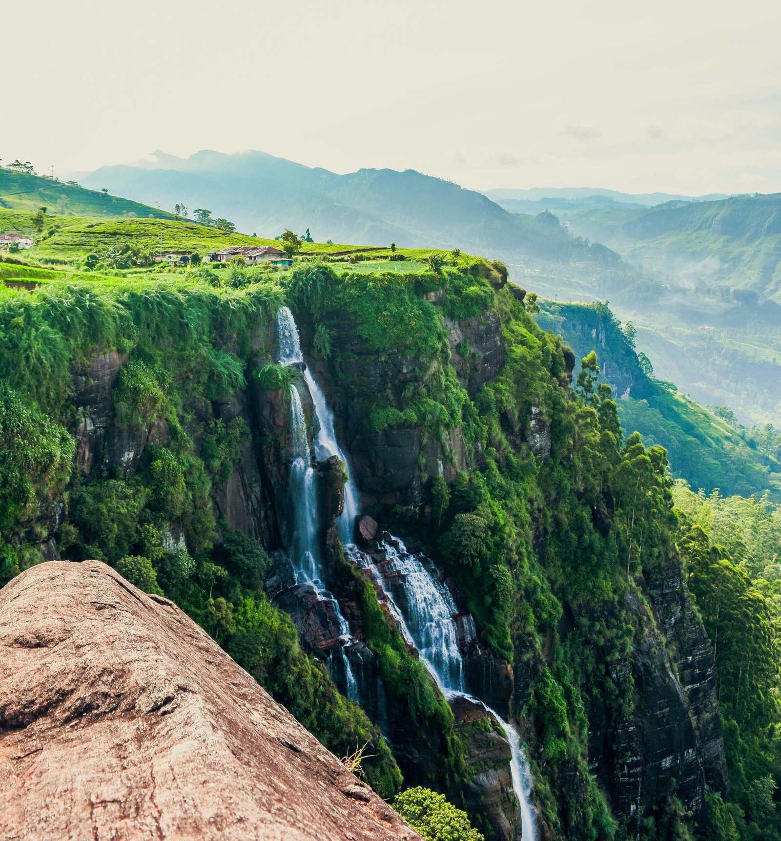 Traveler standing near Gerandi Ella Falls in Sri Lanka, reflecting the grounding and restorative feel of a nature-based yoga retreat.