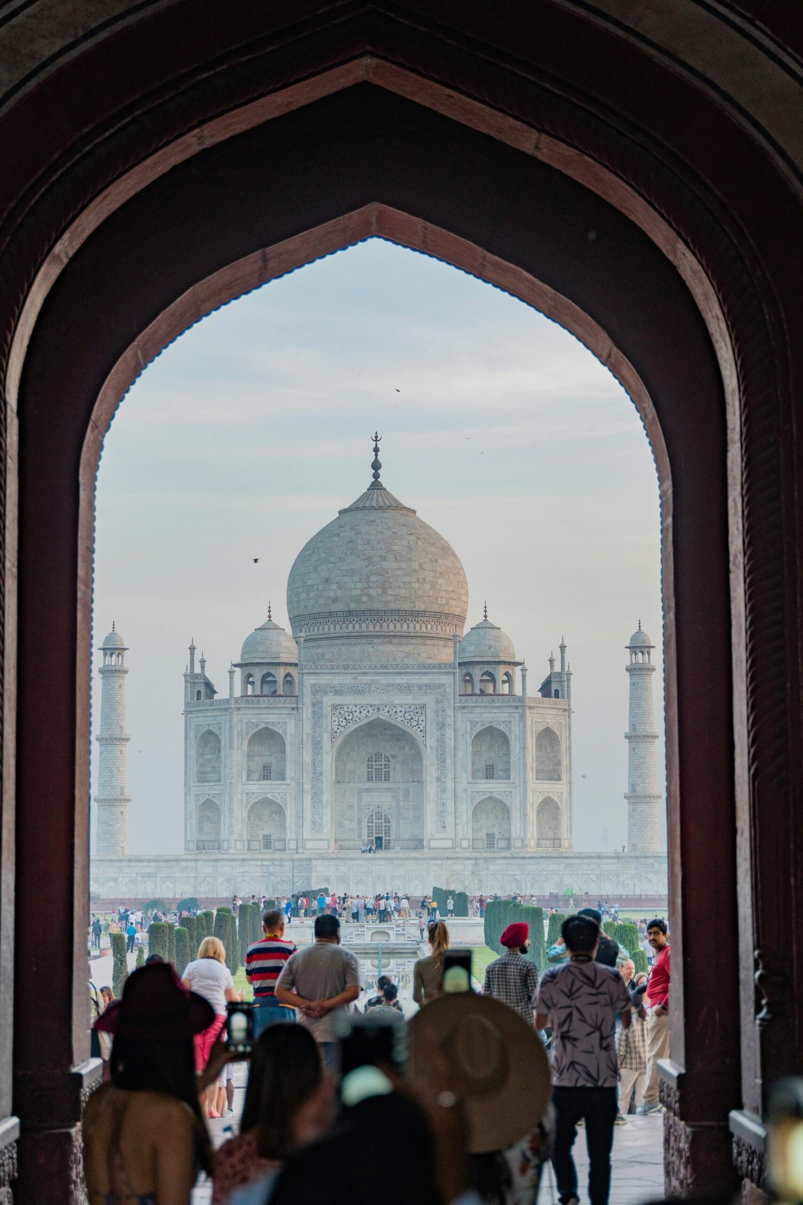 People walking toward the Taj Mahal in Agra, reflecting the cultural depth and reflective travel experience that can enrich a retreat in India.