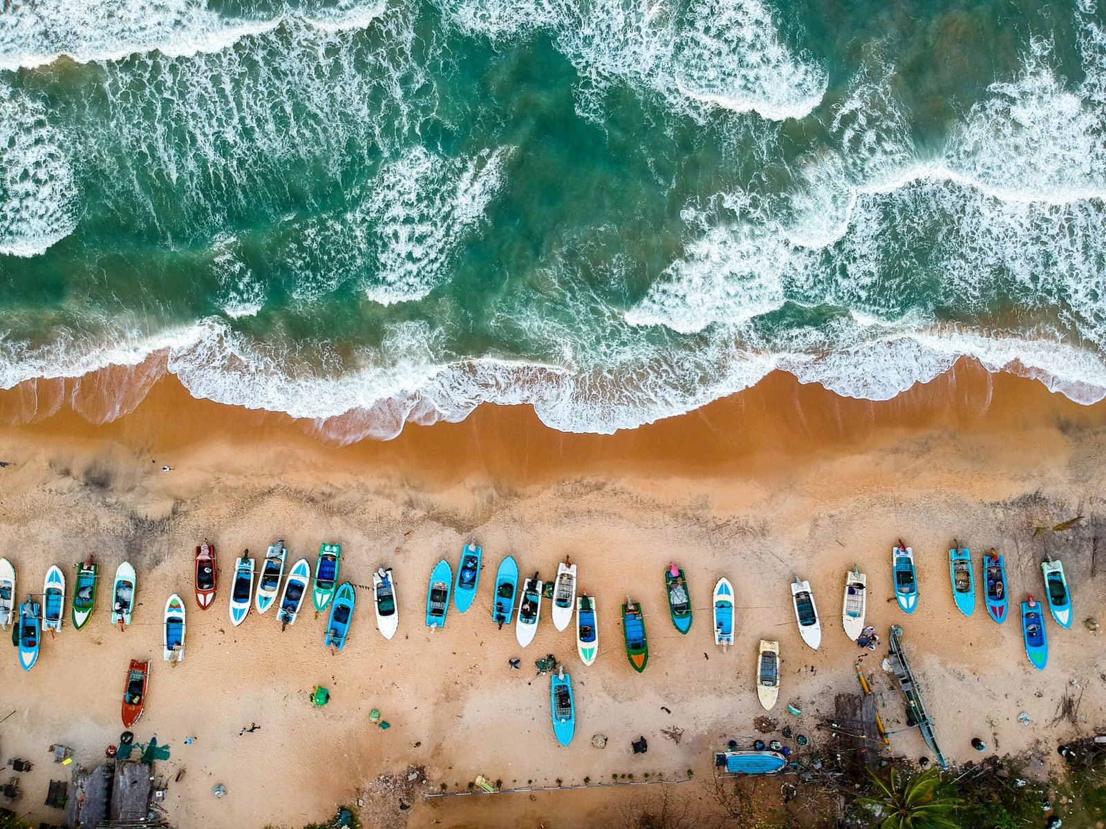 Boats along the coast in Arugam Bay, Sri Lanka, capturing the relaxed coastal energy of a yoga retreat near the sea.