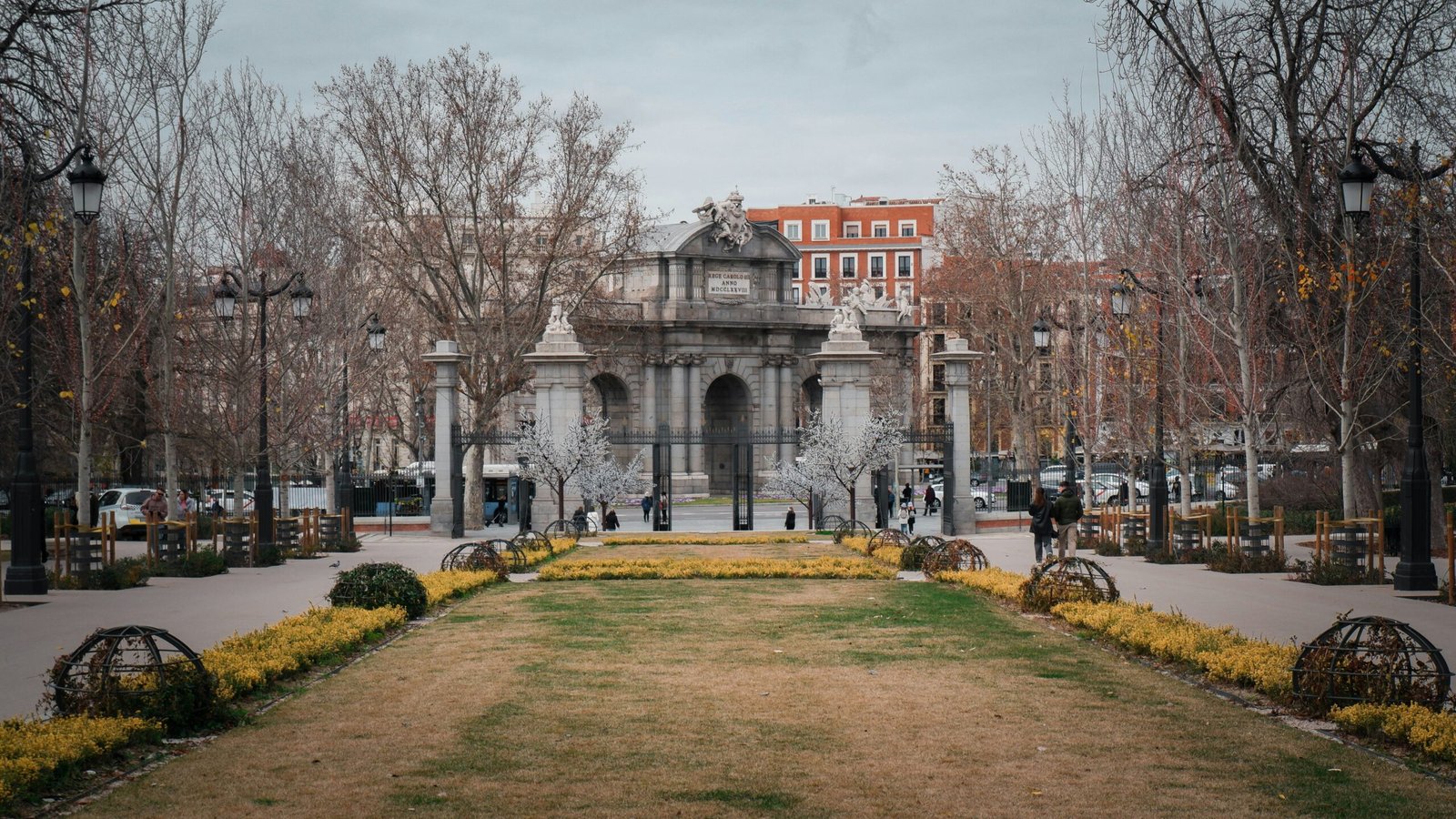Fountain in front of a historic building in Barcelona, Spain, with palm trees and a bright