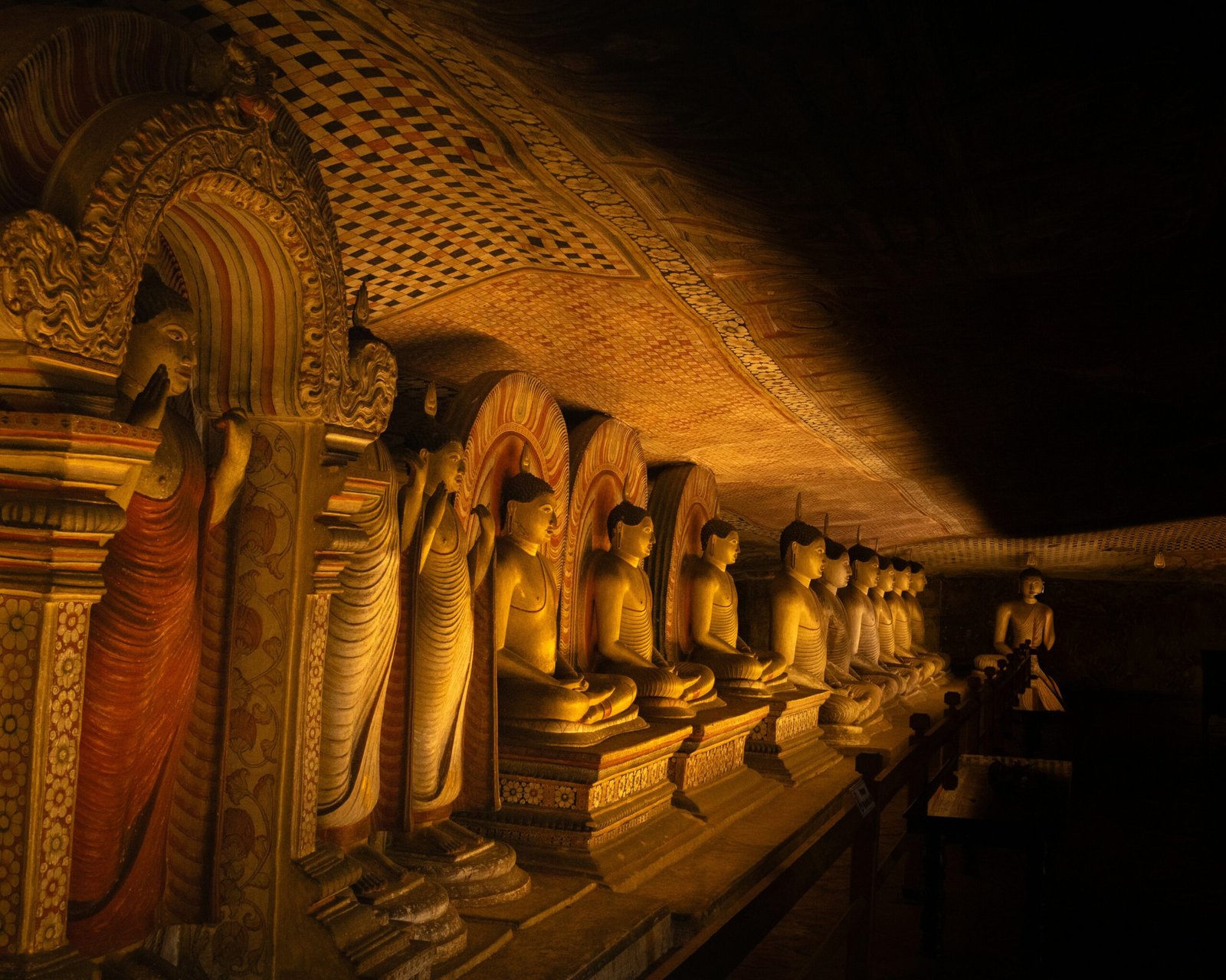 Golden Buddha statues inside the cave temple complex at Dambulla in Sri Lanka.