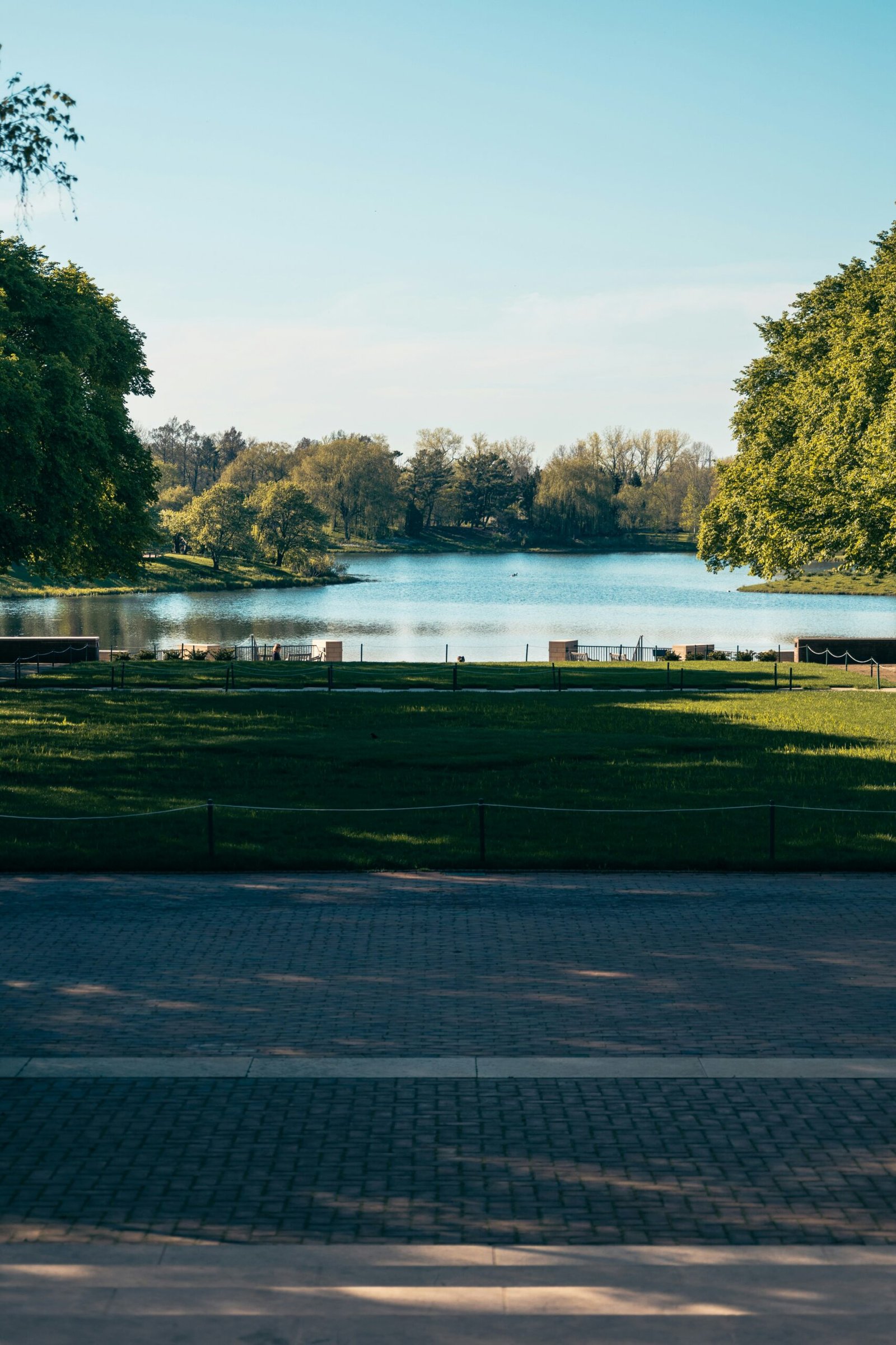 Botanical garden lake scene with spring growth, reflecting a light and restorative retreat mood