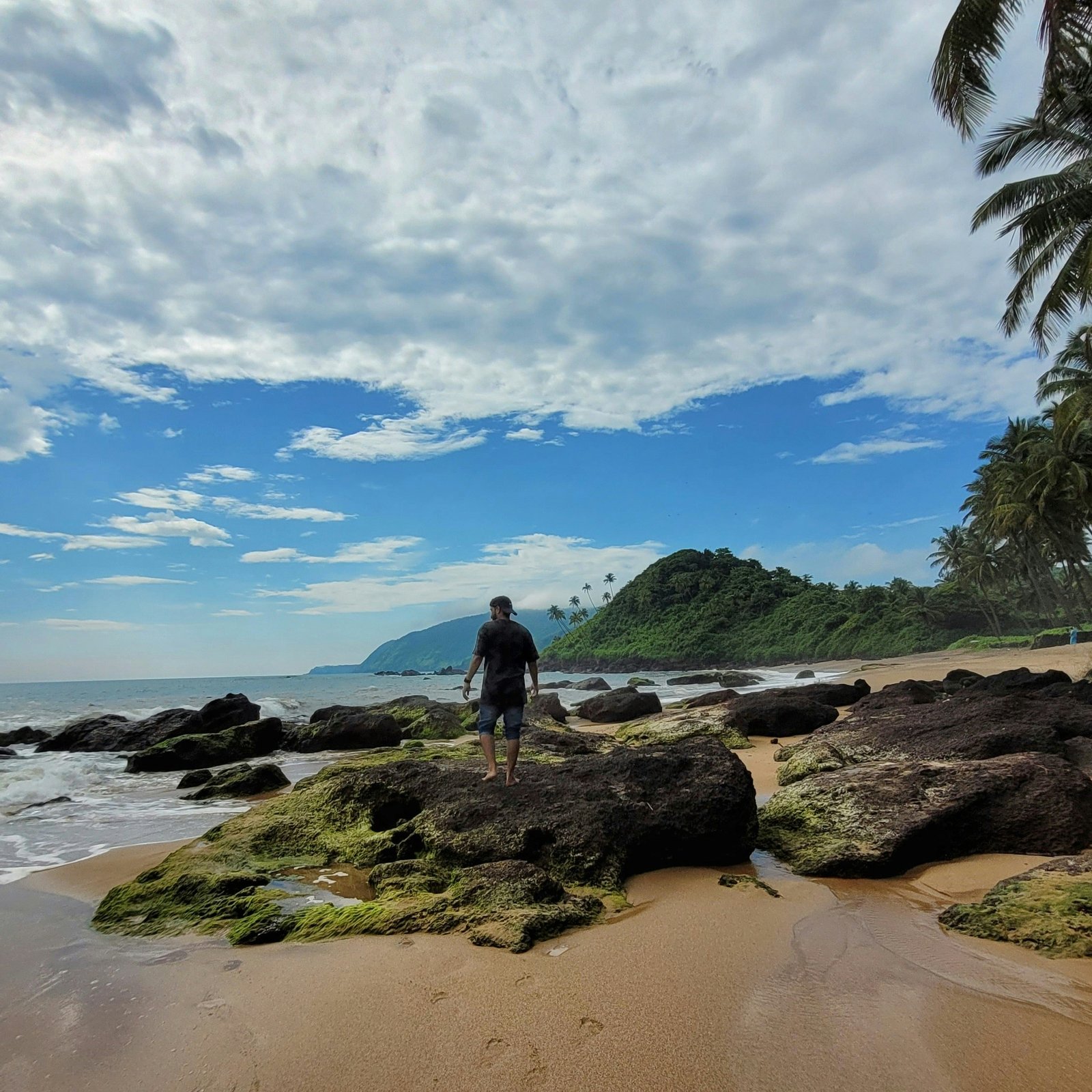 Solo beach walk near an India retreat with ocean views and a calm summer atmosphere