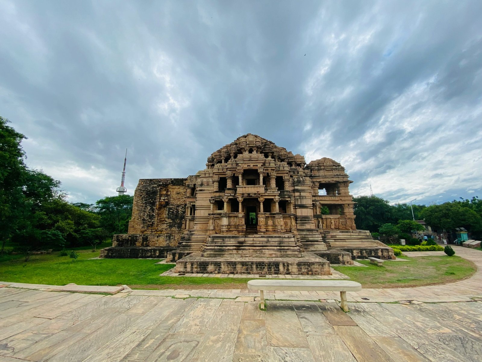 Ancient temple structure in Khajuraho set within open fields, adding a reflective heritage setting to a retreat-focused journey in India.