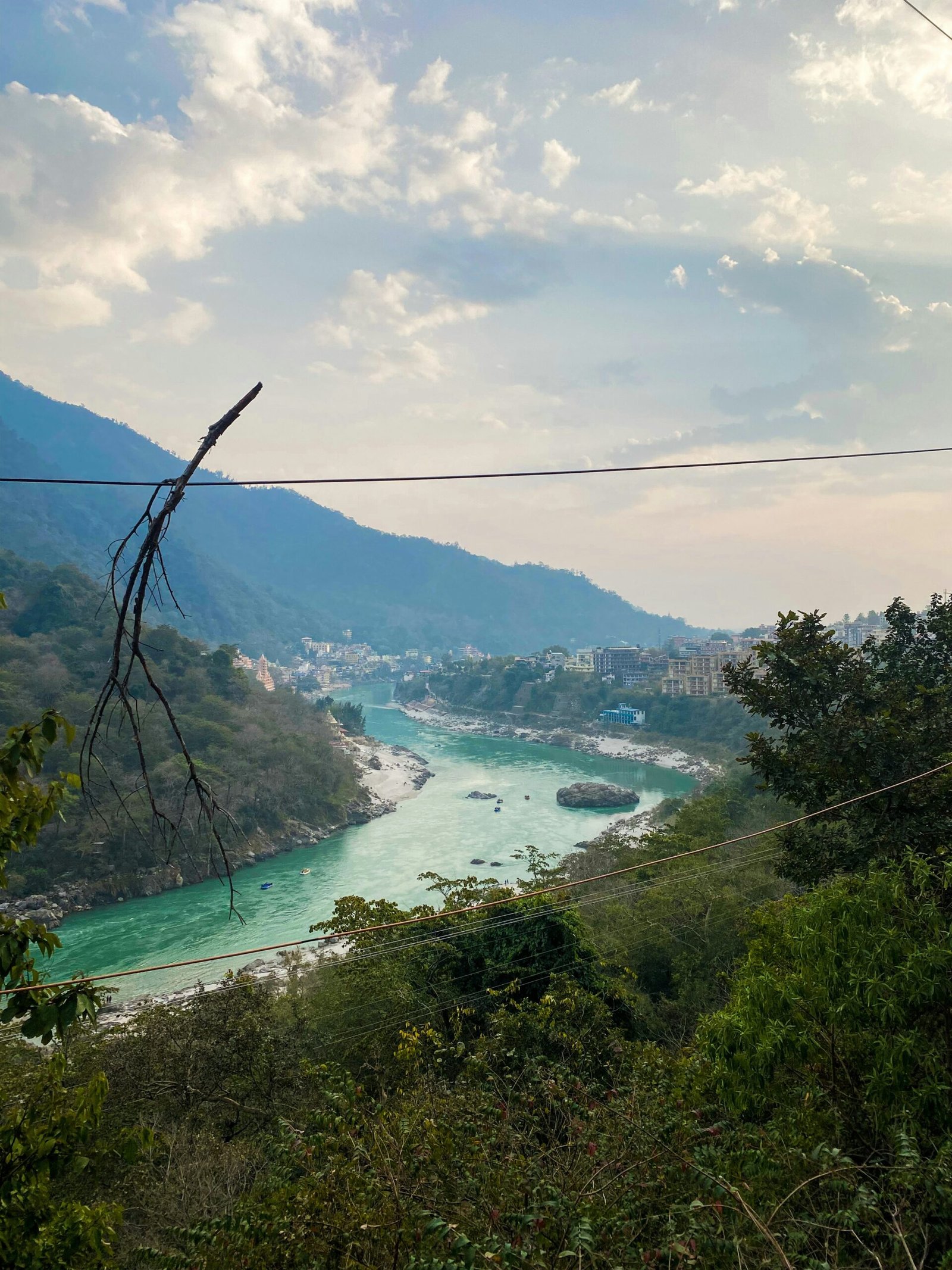 Ganges valley view in Rishikesh with river and green hills, bringing a peaceful foothill landscape to a retreat-focused India article.