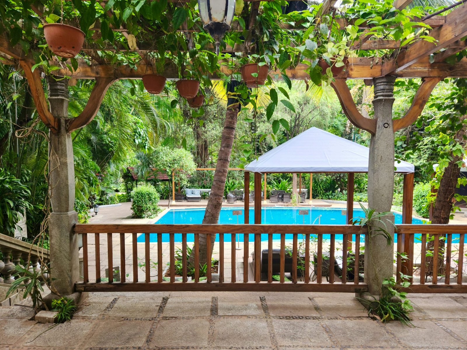 Peaceful retreat gazebo beside a pool designed for rest, quiet mornings, and Ayurvedic stays