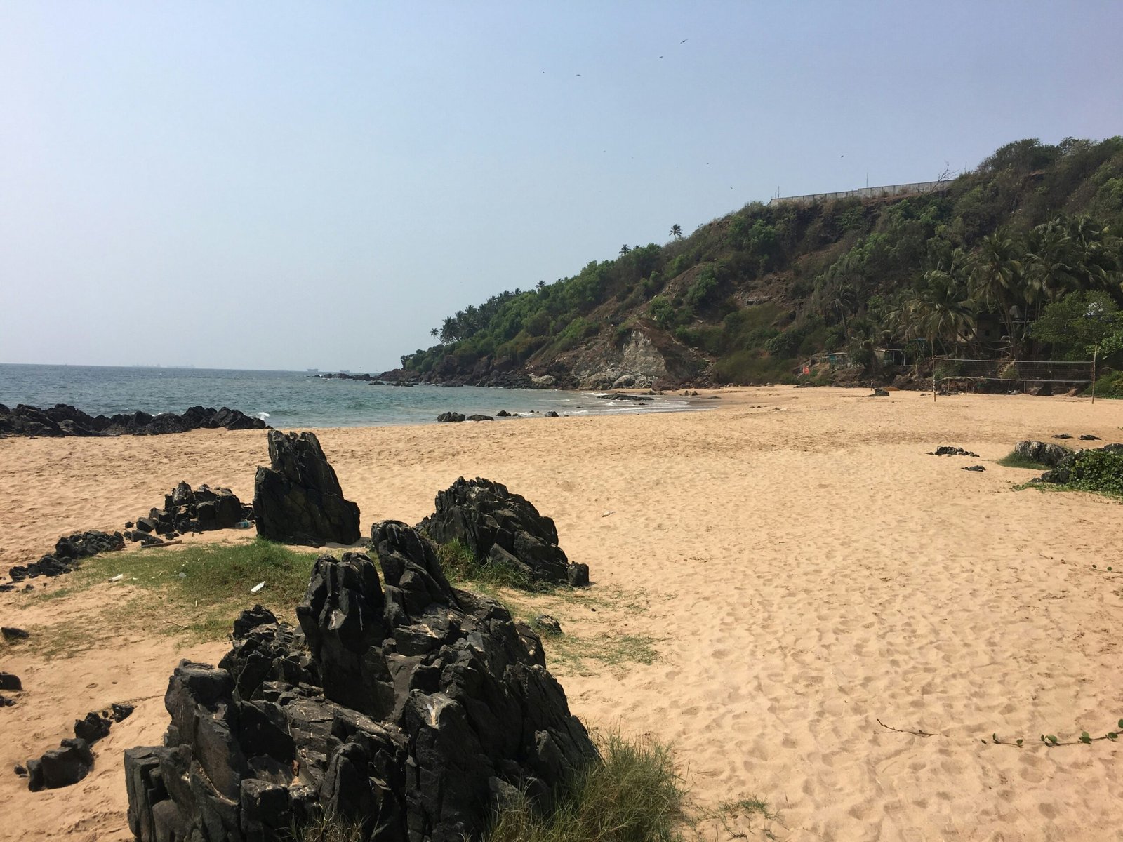 Quiet beach in Goa with soft sand and open sea, suited to a relaxing Ayurveda retreat escape in India